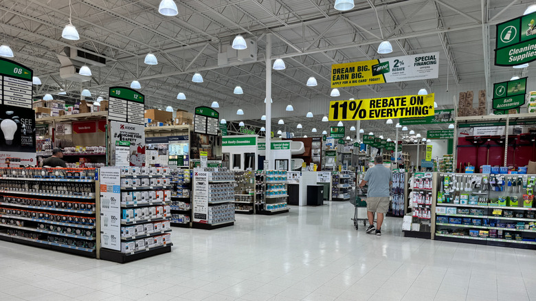 The interior of a Menards store with a large sign advertising 11% rebate on everything