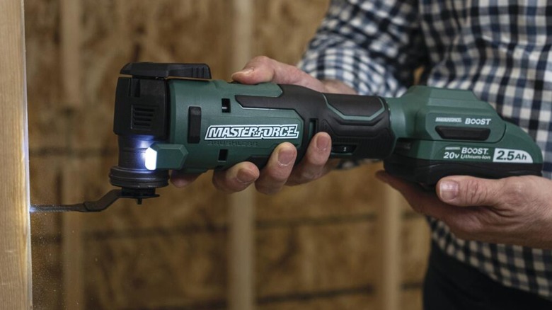 Person using oscillating power tool