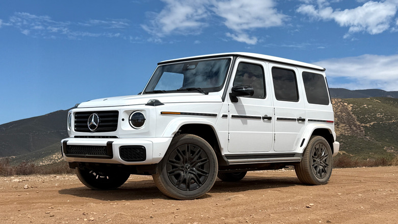 2026 Mercedes-Benz G 580 parked on dirt in front of mountains