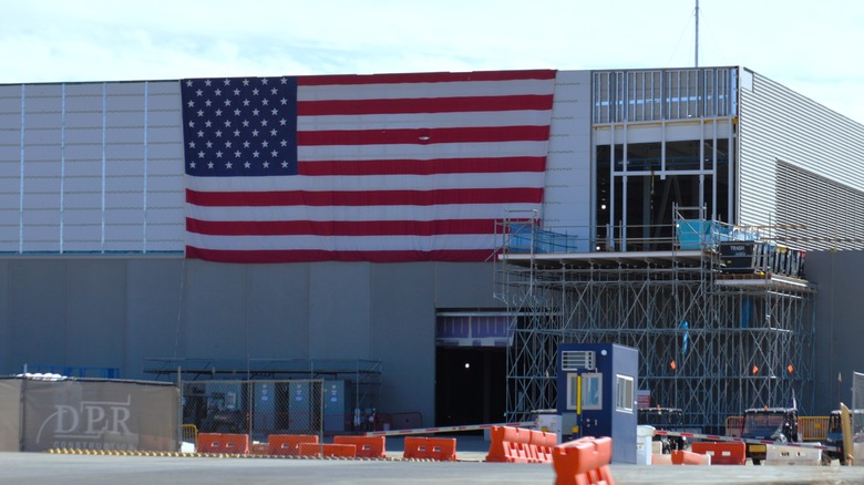 A large META data center under construction with a American flag hanging off it.