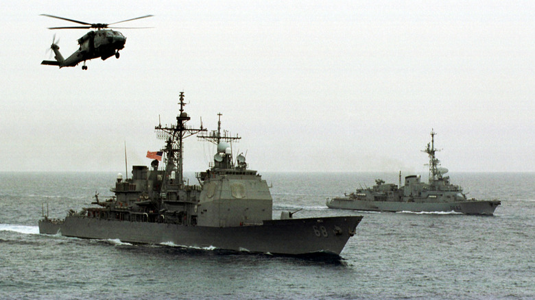 MH-60 Seahawk hovering over a Naval warship