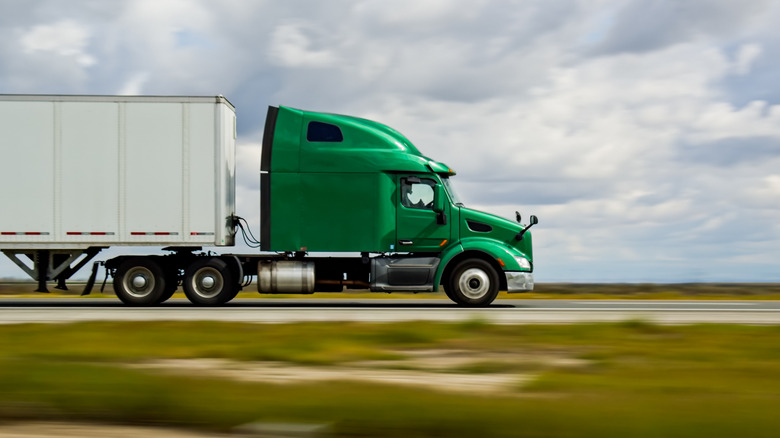 Heavy duty truck driving fast on road