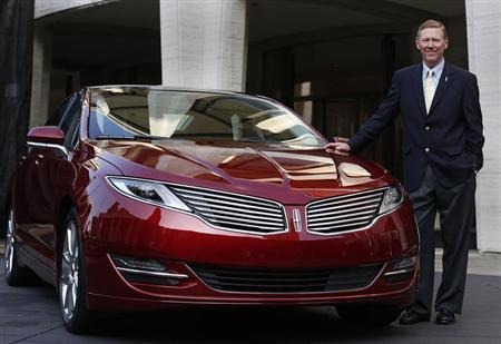 Mulally, president and CEO of Ford Motor Company, stands next to Lincoln MKZ mid-size sedan during news conference in New York