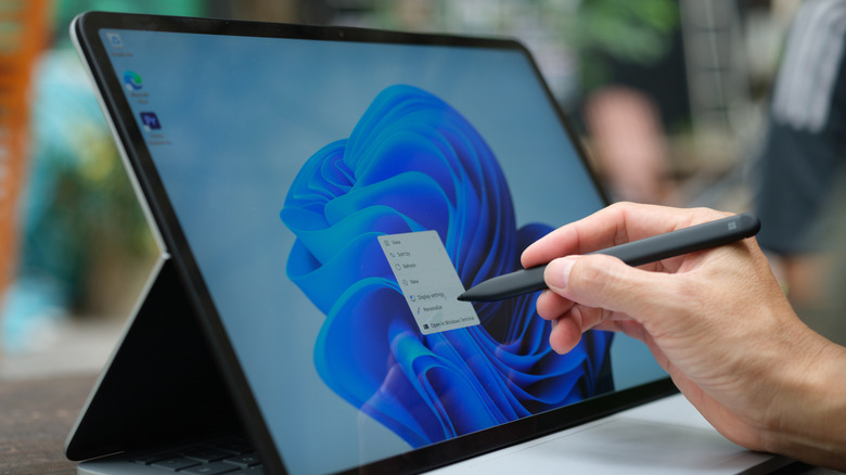 Person using stylus on Microsoft Surface Laptop Studio