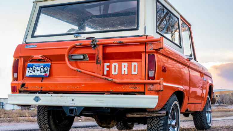 an orange and white vintage Ford bronco