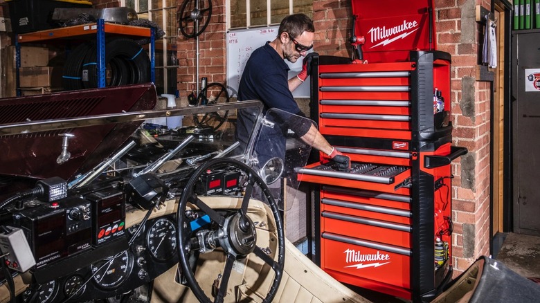 Mechanic opening a Milwaukee Tool Cabinet drawer