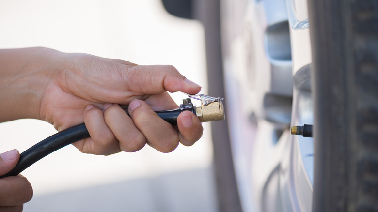 Person using tire inflator