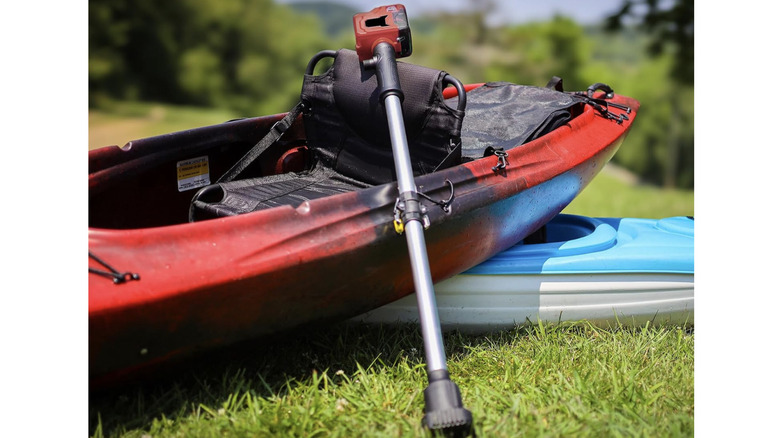 Fordwalt Cordless Stick Water Transfer Pump resting against a kayak