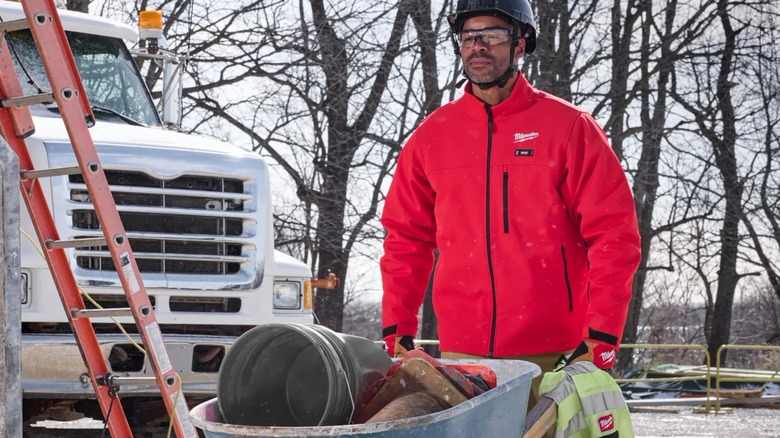 A person wearing a Milwaukee heated jacket outside.