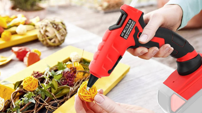 person using a LIVOWALNY cordless hot glue gun for crafting