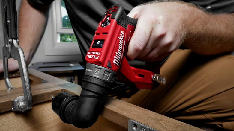 A person using Milwaukee M12 Installation Drill/Driver with a right-angle head