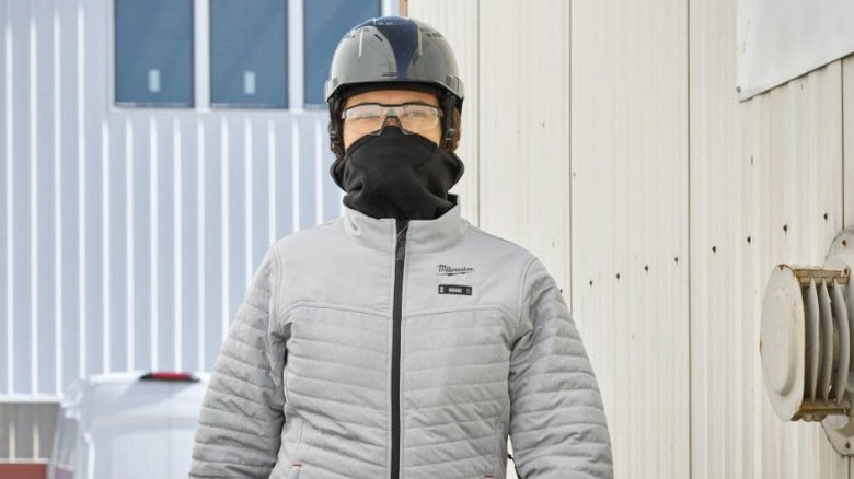 Woman in Milwaukee jacket, helmet and mask