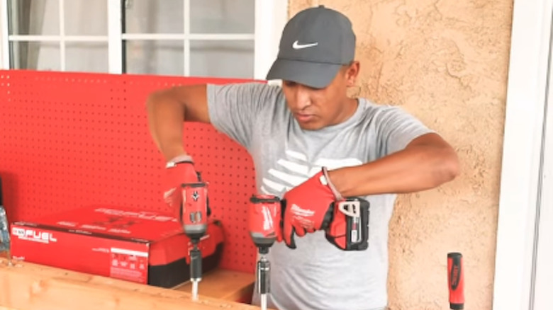 Person uses M12 and M18 impact drivers