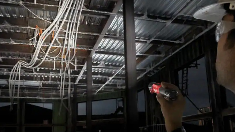 Person using a flashlight to light up a room