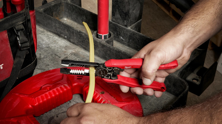 man using Milwaukee Combination Pliers on wire