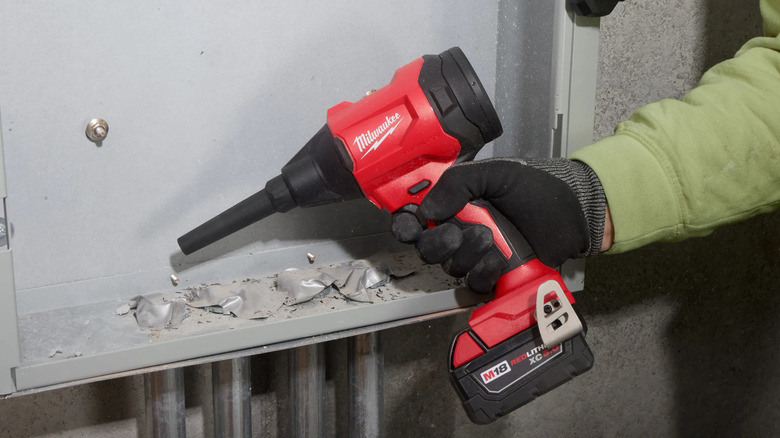 A person using Milwaukee Precision Blower