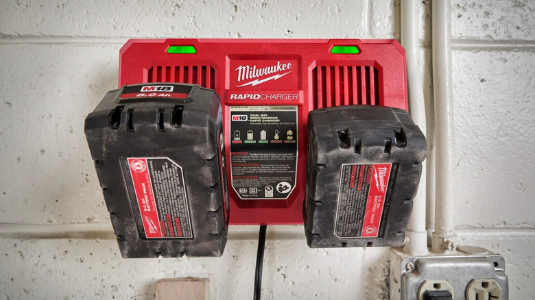 Milwaukee Rapid Charger charging two M18 batteries while mounted on the wall