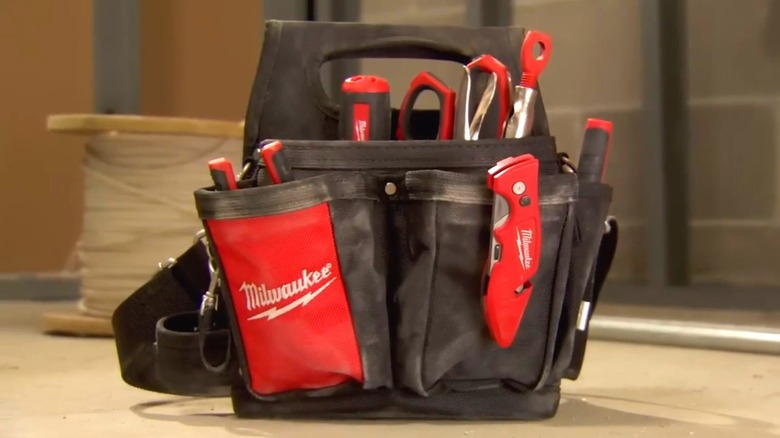 A Milwaukee tool pouch on the ground