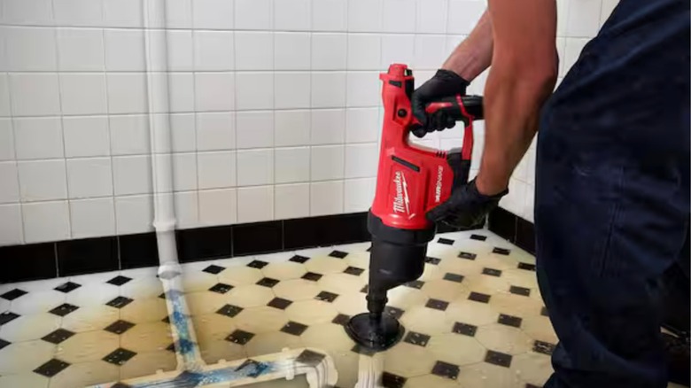 s M12 AirSnake Drain Cleaning Air Gun in use