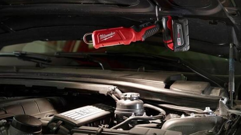 M18 stick light attached to hood of car