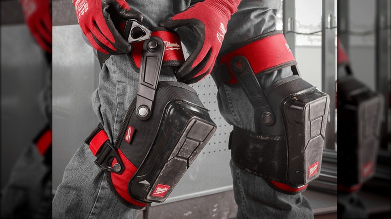 putting on Milwaukee knee pads