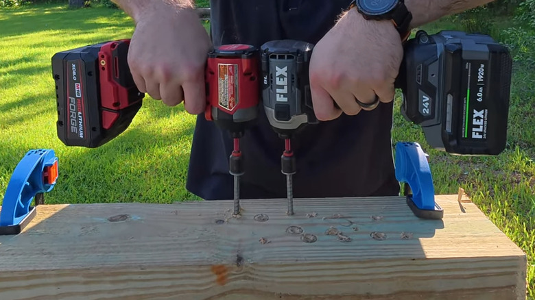 A person using Milwaukee and Flex hammer drills side-by-side for comparison