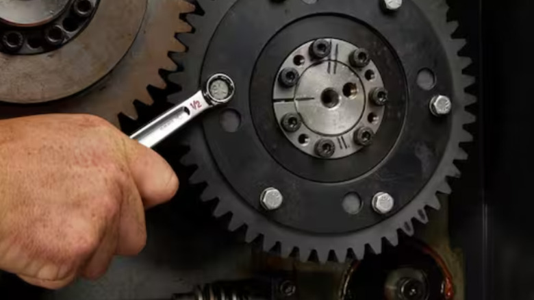 A mechanic using a Milwaukee wrench