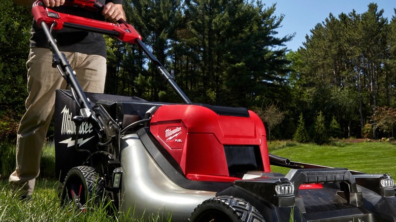 A person using a Milwaukee lawn mower.