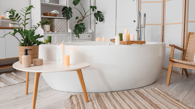 Luxury bathroom with tub and tables with candles