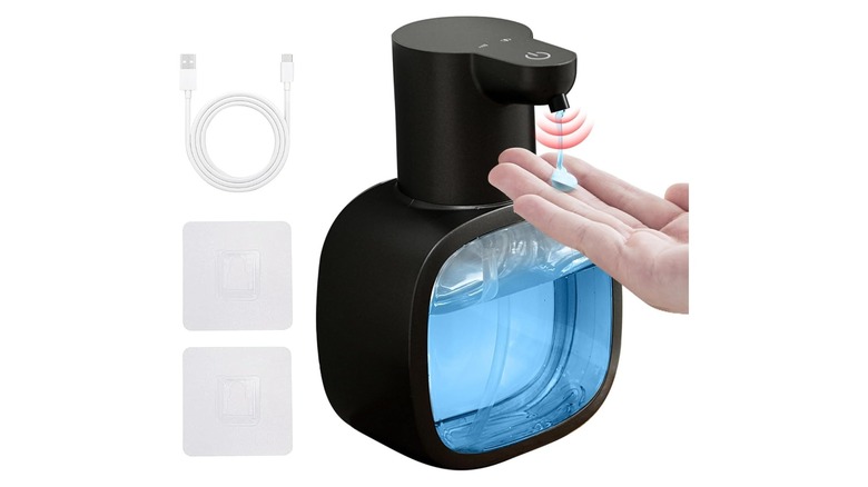 Hand using a touch-free soap dispenser