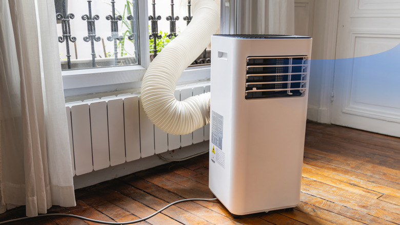 A portable AC running in an apartment during the summer