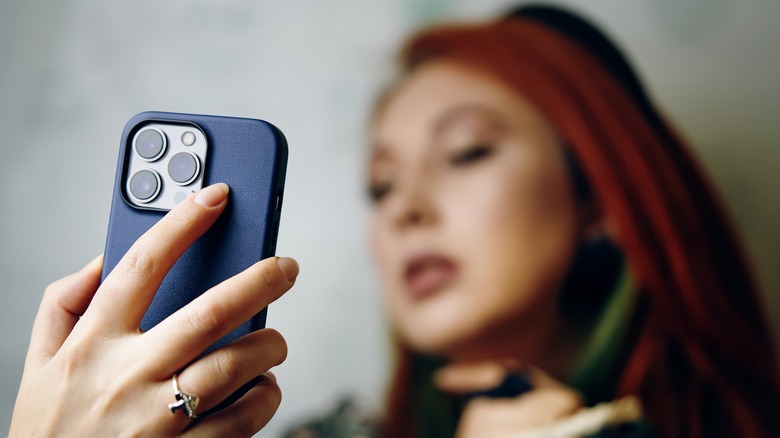 Woman taking a selfie with an iPhone