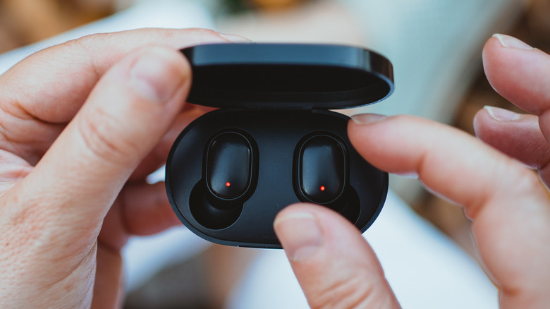 Wireless earbuds being charged 