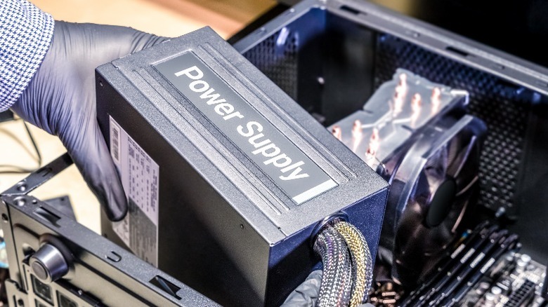 A person holding a PC power supply