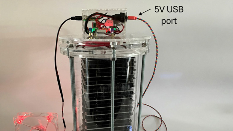 stack of batteries in clear tower with 5V USB inverter on top