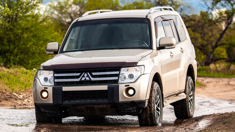 Mitsubishi Montero driving on dirt road