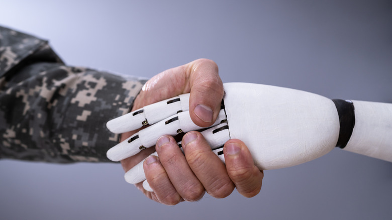 Visualization of soldier shaking a synthetic hand.