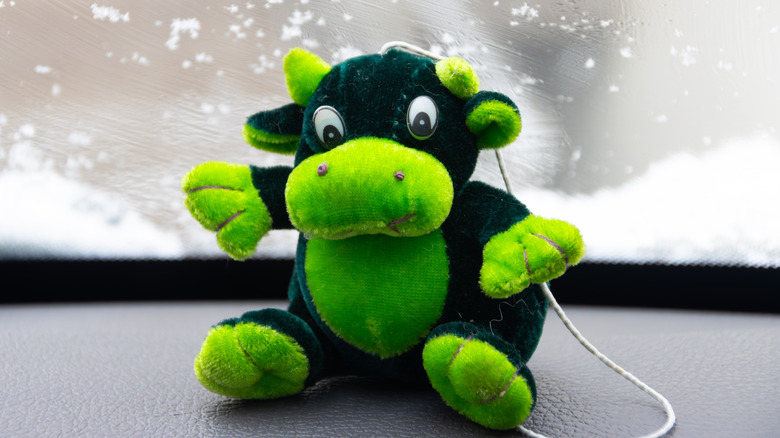 Cow toy on car dashboard