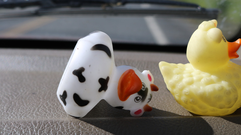 Two rubber ducks on vehicle dashboard