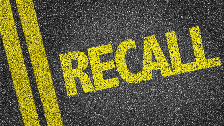 Recall written in yellow over black asphalt