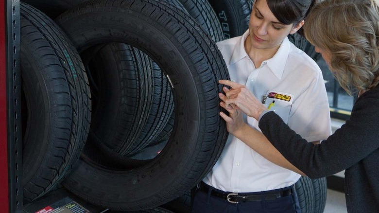 People examining a tire