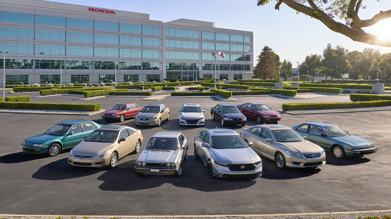 Lineup of all Honda Accord generations parked in front of Honda corporate headquarters.