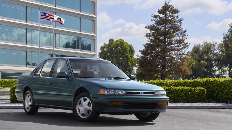 Front 3/4 view of green 1993 Honda Accord parked in front of building.
