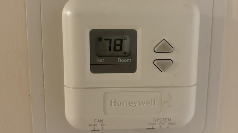 A small white wall-mounted Honeywell thermostat set to 78.