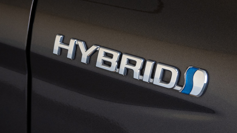 Hybrid badge emblem on a black car body