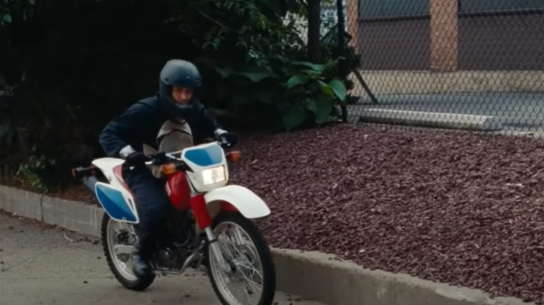 Ryan Gosling riding a white and motorcycle