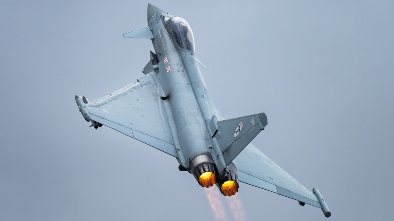 A Royal Air Force Eurofighter Typhoon in flight over grey skies