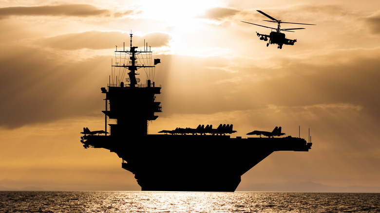 Aircraft carrier silhouette at sunset