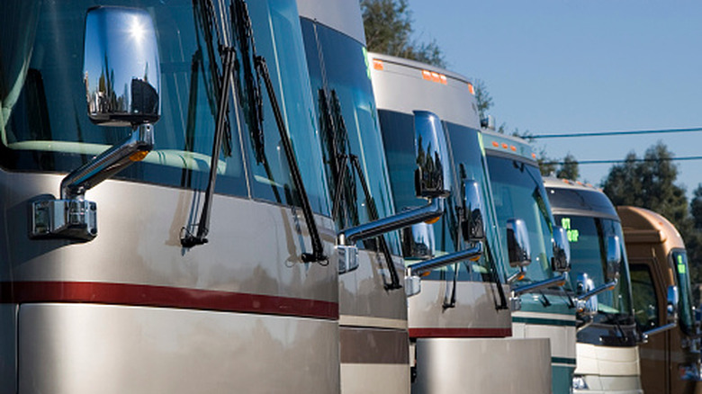 A row of new RVs sitting at a dealership