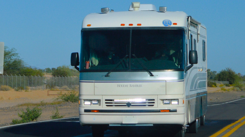 A Holiday Rambler RV traveling along a rural road